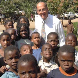 Fogarty Director Dr Roger I Glass with a large group of African children, posing for camera