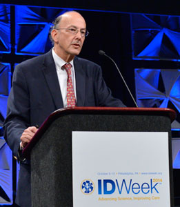 Roger Glass speaks at a podium with sign reading IDWeek 2014