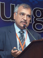 Dr. Sharaf Ali Shah speaking at a podium