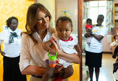U.S. First Lady Melania Trump holds a baby during a visit to children at a children's home in Kenya