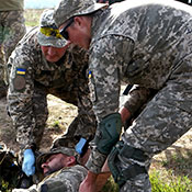 Ukrainian soldiers provide medical response to a simulated casualty situation during an Operational Capabilities Concept evaluation at the International Peacekeeping and Security Centre in Yavoriv, Ukraine, September 2018. The evaluation was being conducted by a multinational OCC evaluation team during the Rapid Trident exercise to assess Ukraine’s military interoperability capacity.