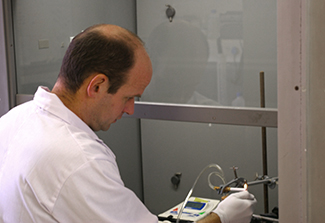 Dr. Richard van-Zyl Smit lights a cigarette which connected to a tube to capture smoke and nicotine to test their effects on macrophages exposed to tuberculosis.