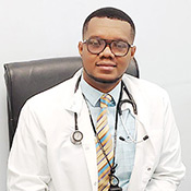 Yvetot Joseph  wears a white lab coat in his office at GHESKIO in Port-au-Prince, Haiti