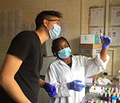 Dr. Andrew Kim working with samples in a lab with a colleague.