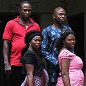 Photo by Dina Patel/HealthySunrise Foundation, pregnant women line up on stairs holding shopping bags, men line up behind each of them