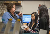 IRSDA grantee Dr Marcy Balunas trains two female researchers in a lab