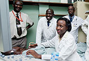 Medical student works with a patient, teacher and other students observe