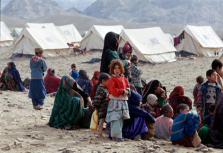 Afghan refugees gather outside tents