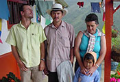 Photo courtesy of Dr. Yakeel Quiroz. A family in Colombia on the porch, mountains in background