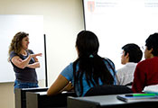 Photo by David Snyder for Fogarty/NIH. Dr. Patty Garcia lectures to a classroom of students.