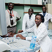 Medical student works with a patient, teacher and other students observe