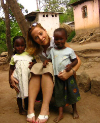 Photo: Dr. Gretchen Birbeck puts her arms around two young Zambian children