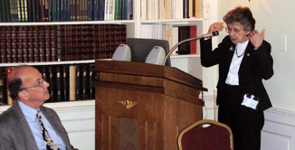 Dr. Rita Colwell speaks to audience members while Dr. Roger I. Glass looks on.