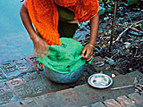 Hands holding a jar covered with cloth