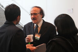 Dr. M.K. Bhan, facing the camera, speaks to two people who have their backs to the camera, one man and one woman.