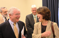 Dr. Michael Merson and Rep. Betty McCollum, speak and smile, with two men in the background