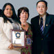 Photo: Sandra Fuentes, Marcia Smith and Jeff Chen holding an award plaque