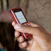 Hand holds mobile phone, photo by Brian DeRenzi