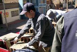 Man opens cardboard boxes in outdoor setting