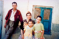 A man and woman pose with their two children