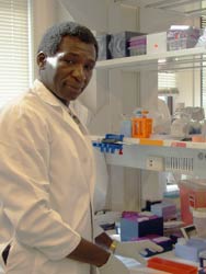 Photo: Dr Ouma in lab coat in laboratory
