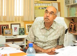 Dr Pape seated at his desk