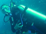 Underwater picture of woman scuba diving in full scuba gear