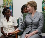 First Lady Laura Bush talks with a young girl
