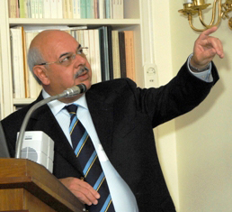 Dr. Alejandero Cravioto points to the screen behind him during his presentation at the Stone House