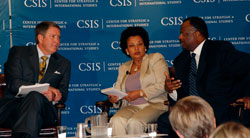 Senator Bill Frist, World Bank's Debrework Zewdie and Robert Matlett of Pfizer sit with the CSIS banner in the background