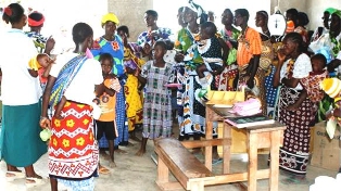 Kids in Kilifi, Kenya standing in a classroom for health education training