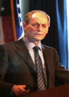 Sir Michael Marmot stands at a podium