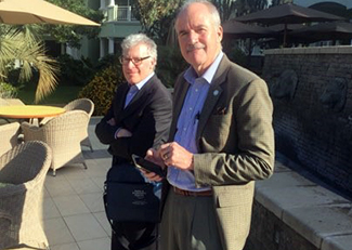 Photo of Rob Eiss and Peter Kilmarx standing on an outside patio