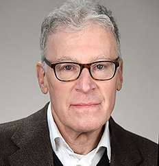 Photo portrait of Rob Eiss wearing glasses, a dark blazer, and a white shirt.