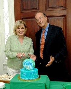 Executive Director for the NIH Foundation Amy Porter stands with Dr Roger Glass before cutting Fogarty's blue and green globe cake