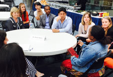 Dr. Denise Russo of NICHD speaks with fellows and scholars during 2015 orientation while seated around a table