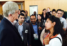 NIH Director Dr Francis Collins speaks with fellows and scholars during 2015 orientation while standing in hallway