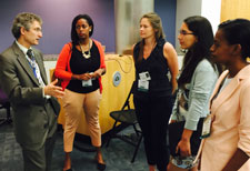 Dr. Gregory Germino of NIDDK speaks with fellows and scholars during 2015 orientation while standing in a conference room