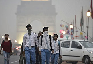 Photo showing young men walking with masks through pollution-induced haze in India