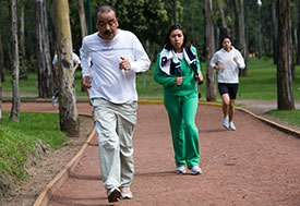 Photo by David Rochkind for Fogarty/NIH. Joggers on outdoor track.