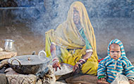 © 2014 Louis Kleynhans, Courtesy of Photoshare, A woman cooks supper in Rajasthan, India