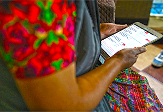 This photograph shows a field researcher from Universidad del Valle de Guatemala (UVG) using a mobile data collection tool for greater efficiency, during door-to-door interviews, for an antimicrobial resistance (AMR) research project in Quetzaltenango, Guatemala