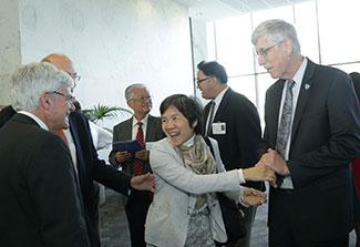 NIH Director Francis Collins greets members of the global health community during an event honoring his contributions