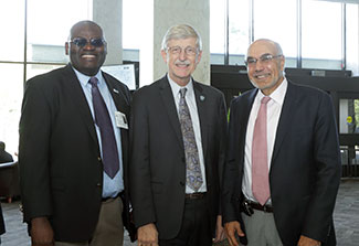 Clement Adebamowo, Francis Collins and Bill Pape pose during an event honoring the global health contributions of Collins