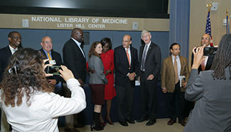 Many gather to have photos taken with NIH Director Francis Collins during an event honoring his global health contributions