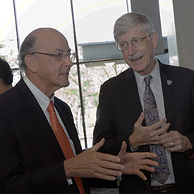 Fogarty Director Glass and NIH Director Collins talk during an event honoring the global health contributions of Collins