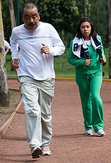 Two joggers on outdoor track.