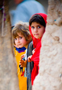 Two young Pakistani children look at camera