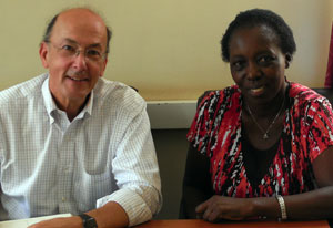 Dr Roger I Glass and Dr Harriet Mayanja-Kizza seated next to each other, both looking at camera