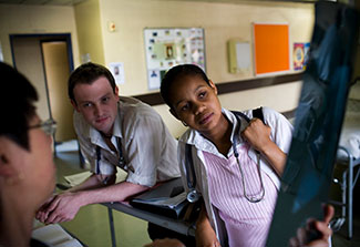 Two medical trainees observe an x-ray in a hallway in South Africa